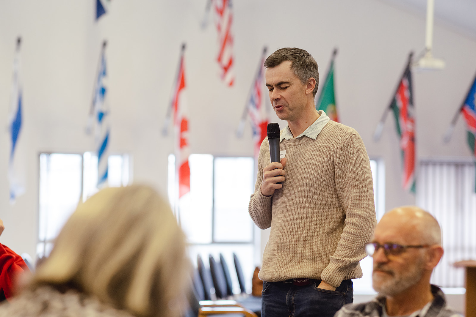 Speaker sharing on a microphone beneath the flags of the nations