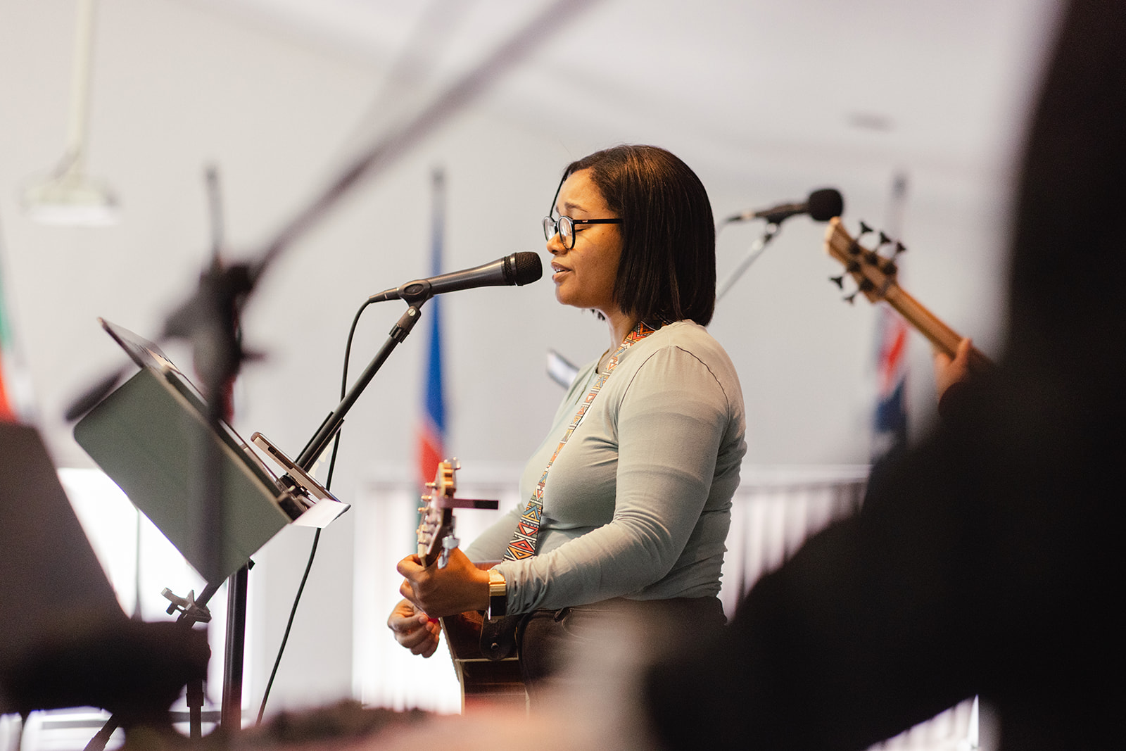 Worship leader singing and playing acoustic guitar