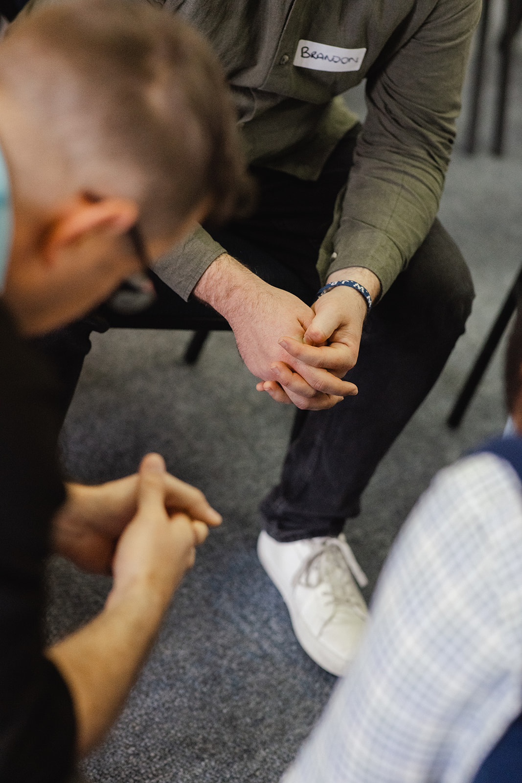 Two people praying together, hands clasped