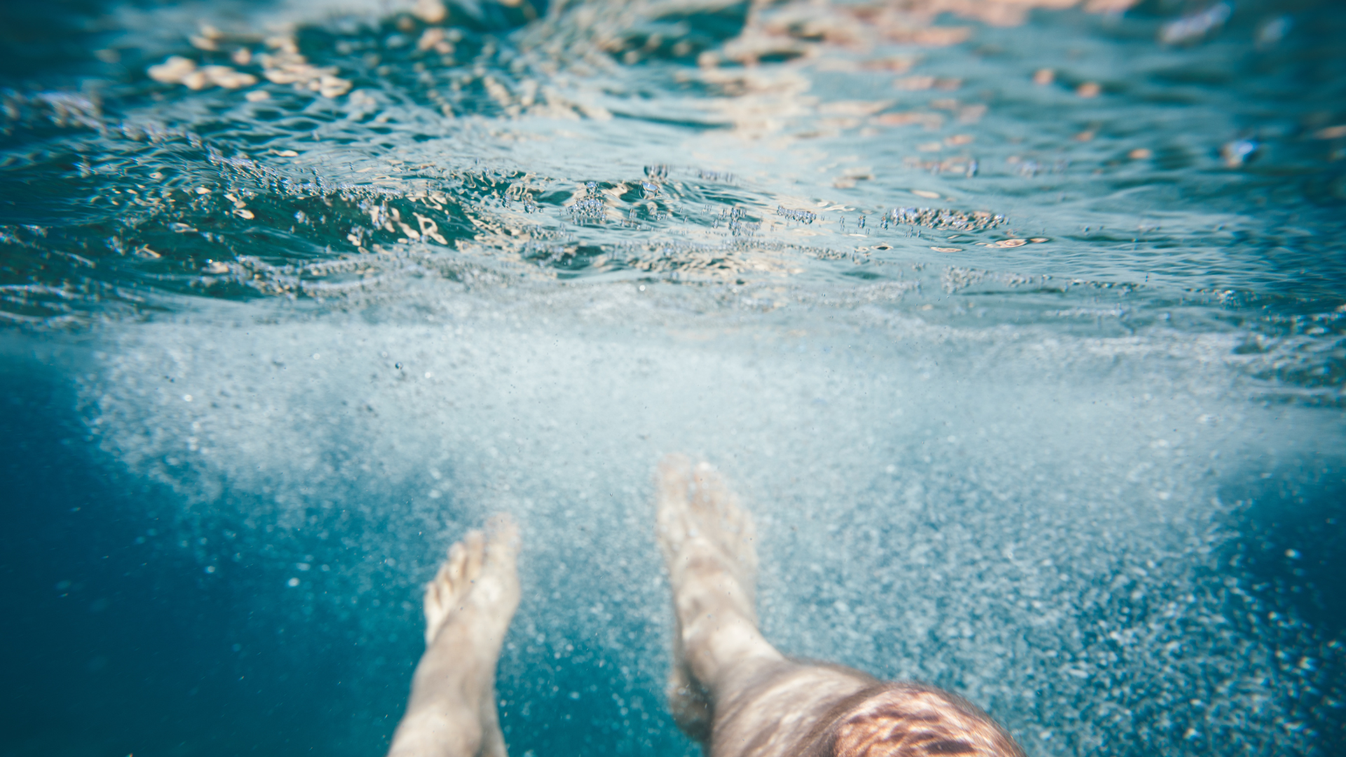 Feet resting beneath the water's surface